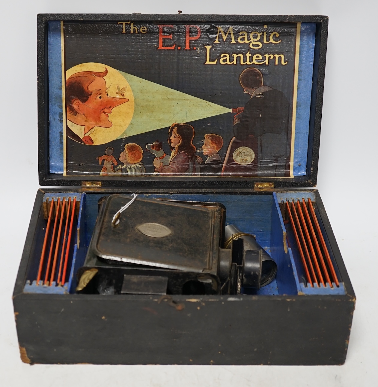 From the Studio of Fred Cuming. Vintage E.P. magic lantern and slides, cased. Condition - fair